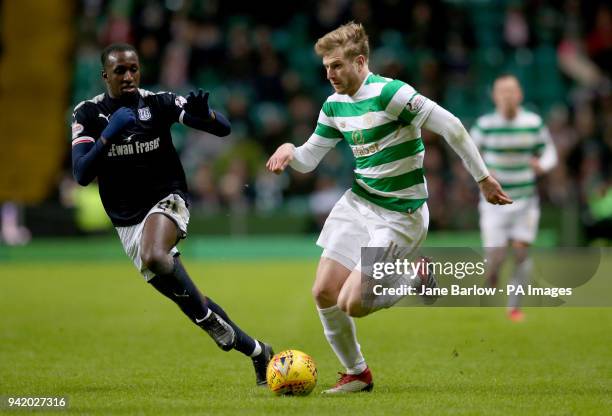 Celtic's Stuart Armstrong and Dundee's Glen Kamara battle for the ball during the Scottish Premiership match at Celtic Park, Glasgow.