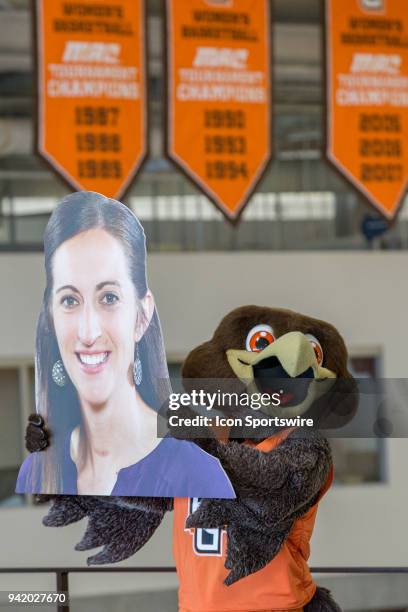 Bowling Green mascot Freddie Falcon holds a big head cutout of Robyn Fralick, who was introduced as the new head coach for the Bowling Green women's...