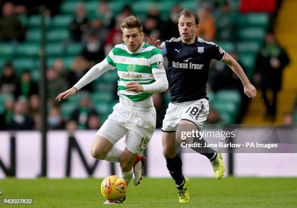 Celtic's Stuart Armstrong and Dundee's Paul McGowan battle for the ball during the Scottish Premiership match at Celtic Park, Glasgow.