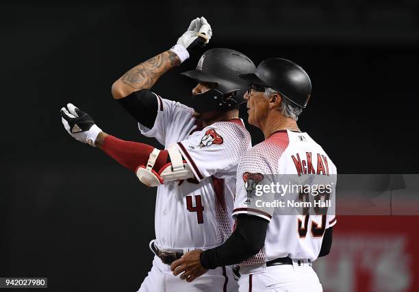 Ketel Marte of the Arizona Diamondbacks gestures to his dugout after hitting an RBI single against the Los Angeles Dodgers as Diamondbacks first base...