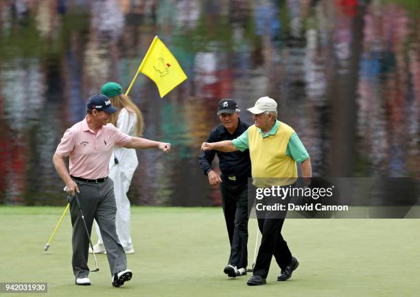 Tom Watson of the United States, Gary Player of South Africa and Jack Nicklaus of the United States show comaraderie during the Par 3 Contest prior...