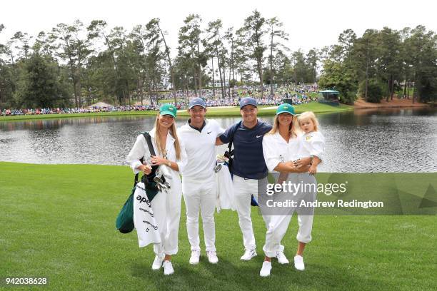 Rory McIlroy of Northern Ireland, his wife Erica , Alexander Noren of Sweden, his wife Jennifer and daughter Iris smile together during the Par 3...