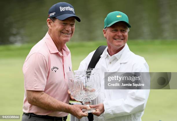 Tom Watson of the United States celebrates with the trophy after winning the Par 3 Contest prior to the start of the 2018 Masters Tournament at...