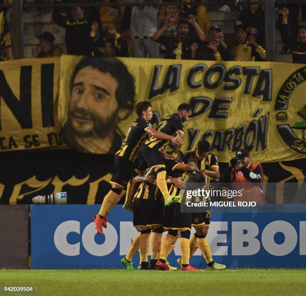 Uruguayan Penarol players celebrate after scoring against Argentinian Atletico Tucuman, during their Copa Libertadores 2018 football match at the...