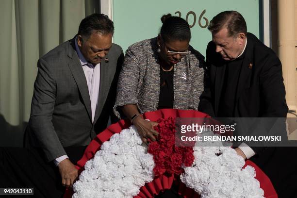 Rev. Jesse Jackson , Terry Lee Freeman , and Rev. Michael Pfleger place a wreath where Martin Luther King Jr. Was assassinated at the Lorraine Motel...