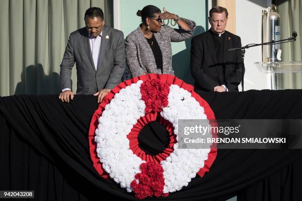 Rev. Jesse Jackson , Terry Lee Freeman , and Rev. Michael Pfleger look on after placing a wreath where Martin Luther King Jr. Was assassinated at the...