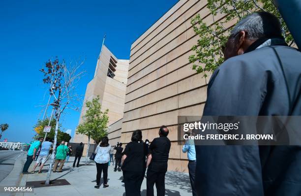 People gather outside the Cathedral of Our Lady of Angels in downtown Los Angeles, California for the tolling of 39 bells on April 4 in honour of...