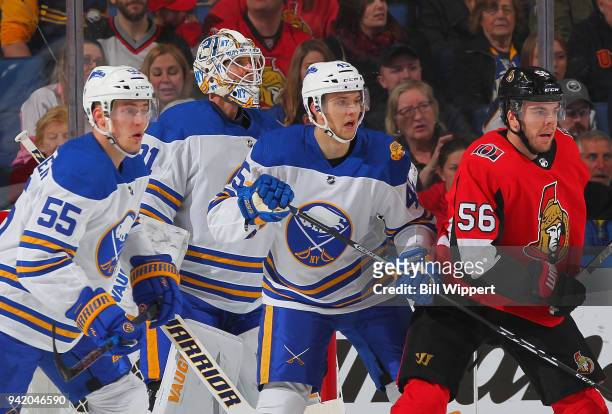 Magnus Paajarvi of the Ottawa Senators is defended by Rasmus Ristolainen, Chad Johnson and Brendan Guhle of the Buffalo Sabres during an NHL game on...