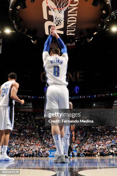 Mario Hezonja of the Orlando Magic hangs onto the net during the game against the Dallas Mavericks on April 4, 2018 at Amway Center in Orlando,...