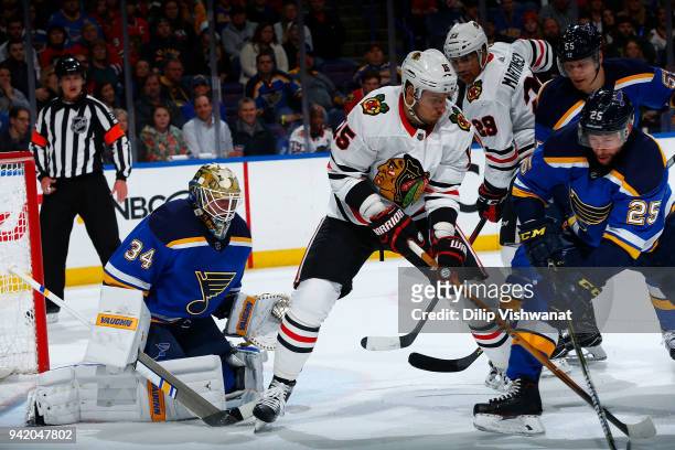 Jake Allen of the St. Louis Blues defends the goal against Artem Anisimov of the Chicago Blackhawks at Scottrade Center on April 4, 2018 in St....