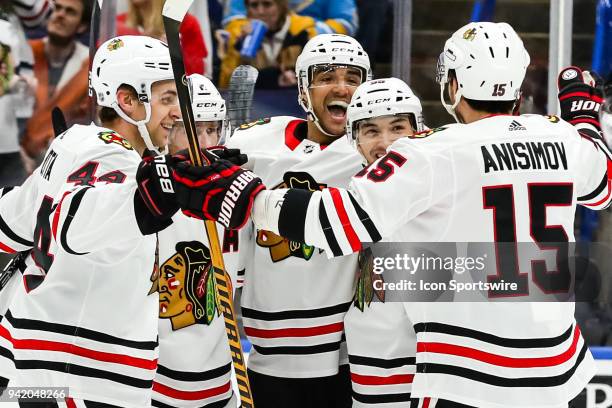 Chicago Blackhawks' Andreas Martinsen, center back, is congratulated by his teammates after scoring a goal during the first period of an NHL hockey...