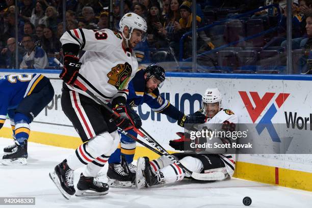 Tomas Jurco of the Chicago Blackhawks and Andreas Martinsen of the Chicago Blackhawks battle against Chris Butler of the St. Louis Blues at Scottrade...