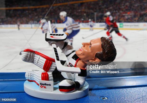 Dominik Hasek bobblehead given to fans sits atop the boards during an NHL game between the Buffalo Sabres and the Ottawa Senators on April 4, 2018 at...