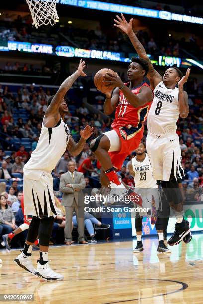 Jrue Holiday of the New Orleans Pelicans shoots over MarShon Brooks of the Memphis Grizzlies during the first half of a NBA game at the Smoothie King...