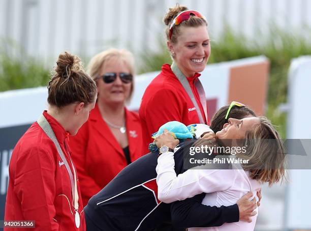 Former triathlete Emma Snowsill congratulates gold medalist Flora Duffy of Bermuda during the medal ceremony for the Women's Triathlon on day one of...