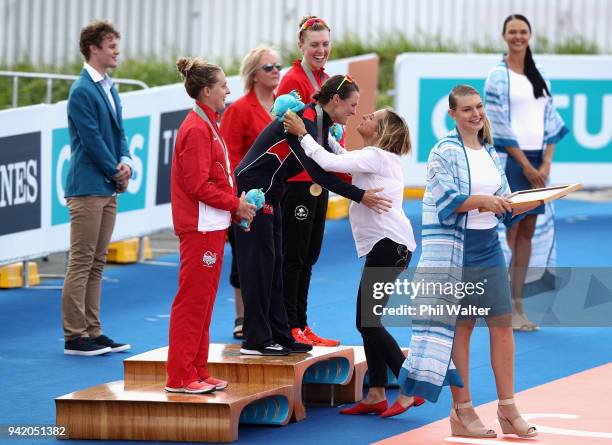 Former triathlete Emma Snowsill congratulates gold medalist Flora Duffy of Bermuda during the medal ceremony for the Women's Triathlon on day one of...