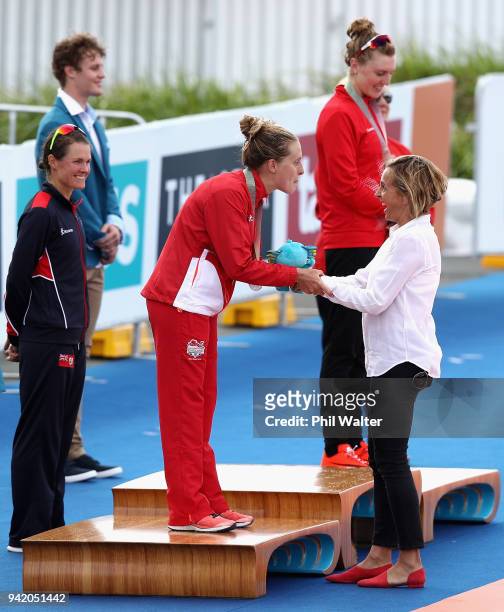 Former triathlete Emma Snowsill congratulates silver medalist Jessica Learmonth of England during the medal ceremony for the Women's Triathlon on day...