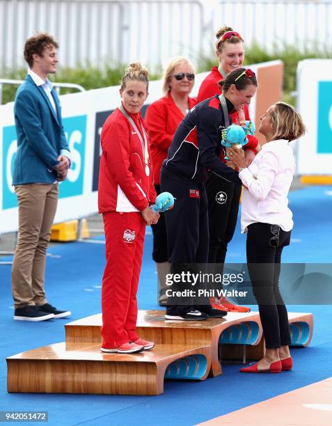 Former triathlete Emma Snowsill congratulates gold medalist Flora Duffy of Bermuda during the medal ceremony for the Women's Triathlon on day one of...