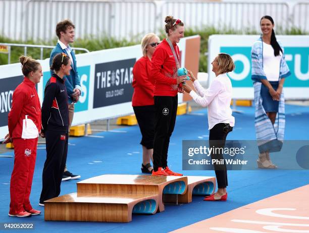 Former triathlete Emma Snowsill congratulates bronze medalist Joanna Brown of Canada during the medal ceremony for the Women's Triathlon on day one...