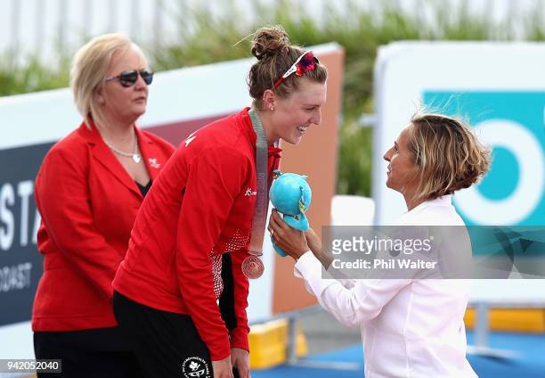 Former triathlete Emma Snowsill congratulates bronze medalist Joanna Brown of Canada during the medal ceremony for the Women's Triathlon on day one...