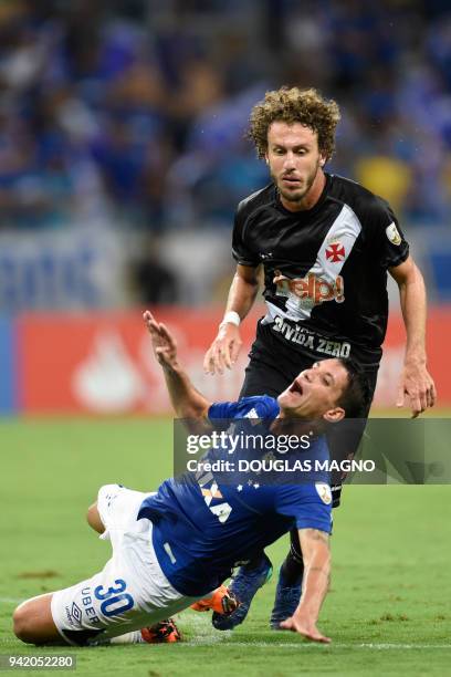 Thiago Neves of Brazil's Cruzeiro , falls in front of Galhardo of Brazil's Vasco da Gama, during their 2018 Copa Libertadores match held at Mineirao...