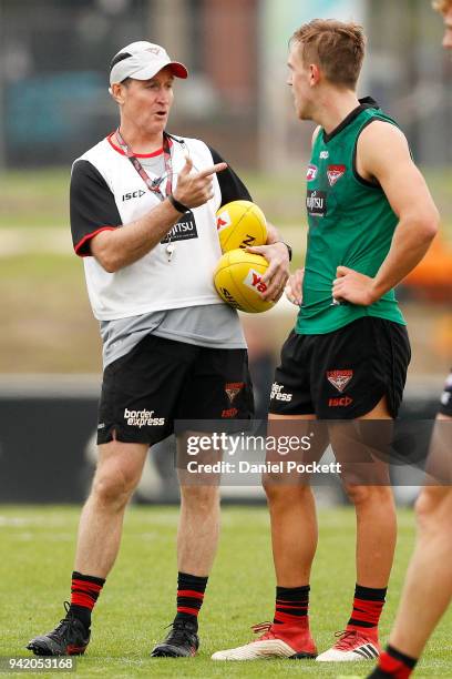 Bombers head coach John Worsfold talks to Joshua Begley of the Bombers during an Essendon Bombers training session at The Hangar on April 5, 2018 in...