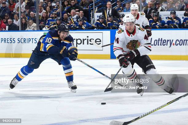 Jan Rutta of the Chicago Blackhawks handles the puck as Brayden Schenn of the St. Louis Blues pressures at Scottrade Center on April 4, 2018 in St....