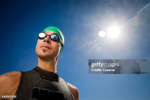 young man portrait in a triathlon race suit - race suit stock pictures, royalty-free photos & images