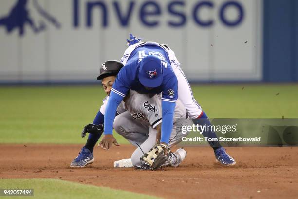 Gift Ngoepe of the Toronto Blue Jays turns a double play over pinch-runner Leury Garcia of the Chicago White Sox at second base in the eighth inning...