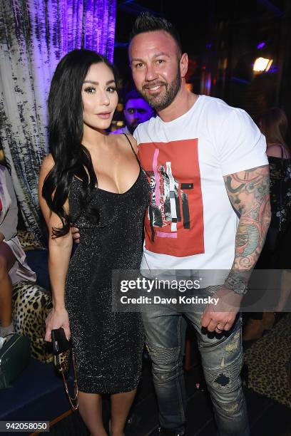 Television personality Jenni 'JWoww' Farley and Roger Mathews attend MTV's "Jersey Shore Family Vacation" New York premiere party at PHD at the Dream...