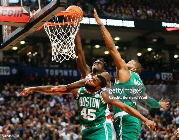 Toronto Raptors forward Pascal Siakam struggles past Boston Celtics guard Kadeem Allen and Boston Celtics center Greg Monroe in the 3rd quarter as...