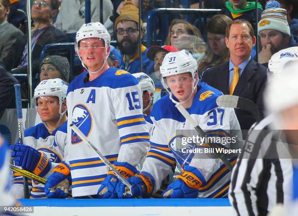 Kyle Okposo, Jack Eichel, Casey Mittelstadt of the Buffalo Sabres, and Head Coach Phil Housley watch the action during an NHL game against the Ottawa...