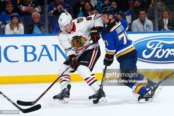 Connor Murphy of the Chicago Blackhawks controls the puck against Vladimir Sobotka of the St. Louis Blues at Scottrade Center on April 4, 2018 in St....