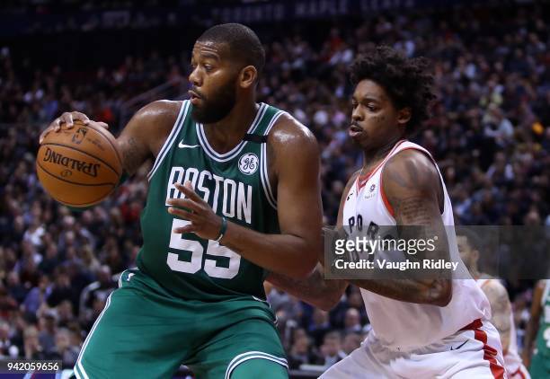 Greg Monroe of the Boston Celtics dribbles the ball as Lucas Nogueira of the Toronto Raptors defends during the second half of an NBA game at Air...