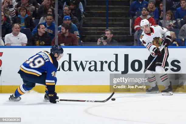 Ivan Barbashev of the St. Louis Blues blocks a pass attempt made by Jan Rutta of the Chicago Blackhawks at Scottrade Center on April 4, 2018 in St....