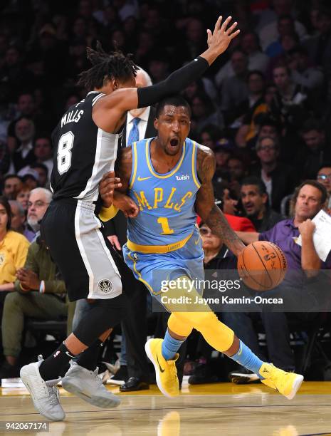 Kentavious Caldwell-Pope of the Los Angeles Lakers drives against Patty Mills of the San Antonio Spurs in the first half of the game at Staples...