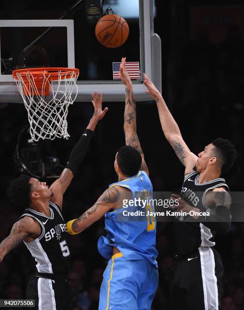 Kyle Kuzma of the Los Angeles Lakers gets by Dejounte Murray and Danny Green of the San Antonio Spurs for a basket in the second half of the game...