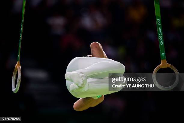 David Bishop of New Zeland competes on the rings during the men's team final and individual qualification in the artistic gymnastics event during the...