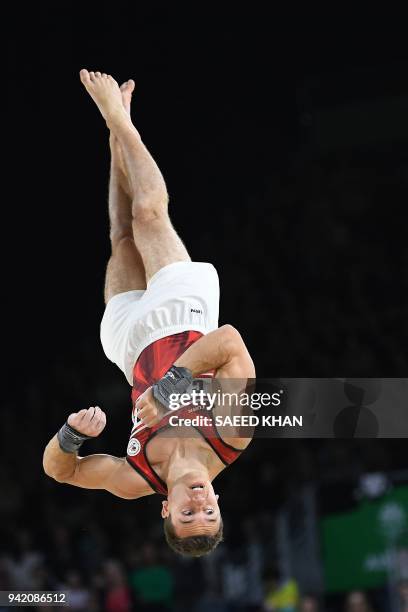 Canada's Rene Cournoyer competes on the floor exercise during the men's team final and individual qualification in the artistic gymnastics event...