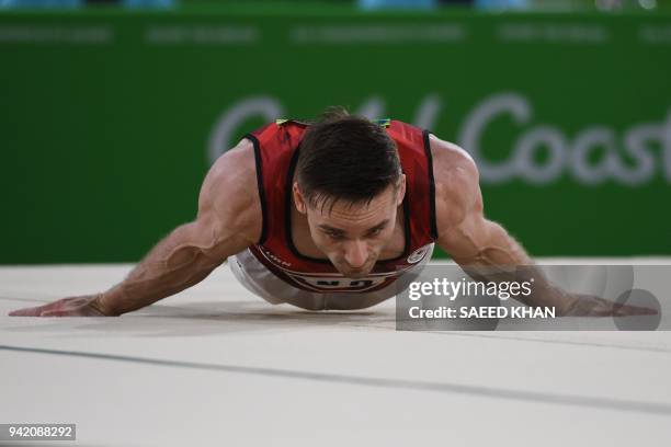 Canada's Scott Morgan competes on the floor exercise during the men's team final and individual qualification in the artistic gymnastics event during...