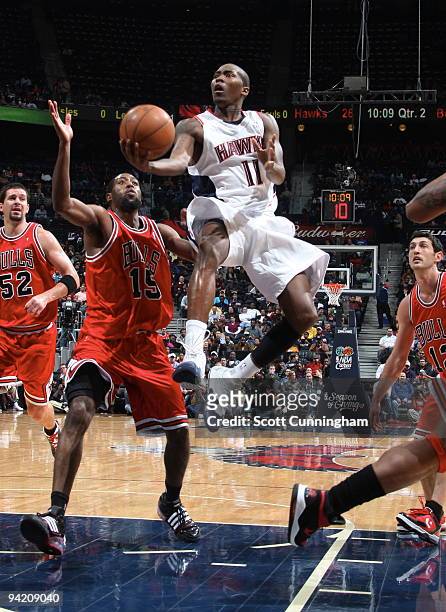 Jamal Crawford of the Atlanta Hawks puts up a shot against John Salmons of the Chicago Bulls on December 9, 2009 at Philips Arena in Atlanta,...