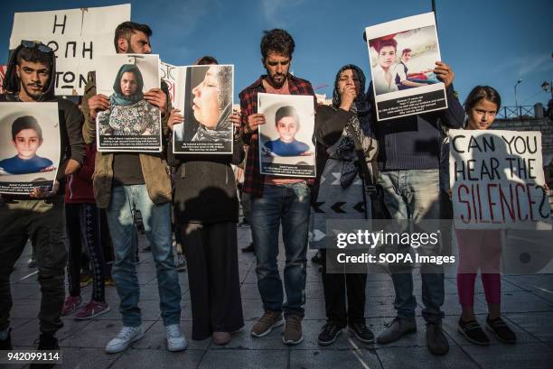 Protesters holding banners with photographs of the drowned people. 16 refugees drowned when the small boat they were traveling on capsized near...