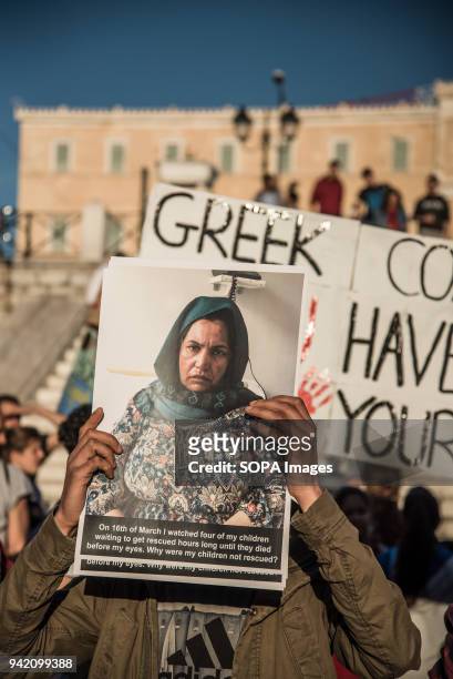 Protesters holding banners with photographs of the drowned people. 16 refugees drowned when the small boat they were traveling on capsized near...