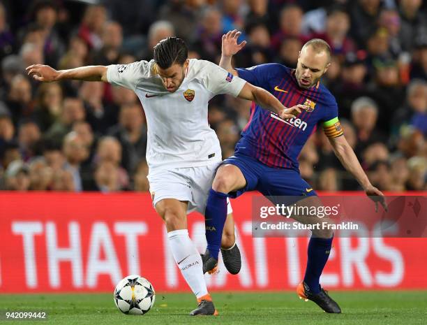 Andrs Iniesta of Barcelona is challenged by Kevin Strootman of Roma during the quarter final first leg UEFA Champions League match between FC...