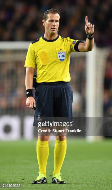 Referee Danny Makkelie points during the quarter final first leg UEFA Champions League match between FC Barcelona and AS Roma at Camp Nou on April 4,...