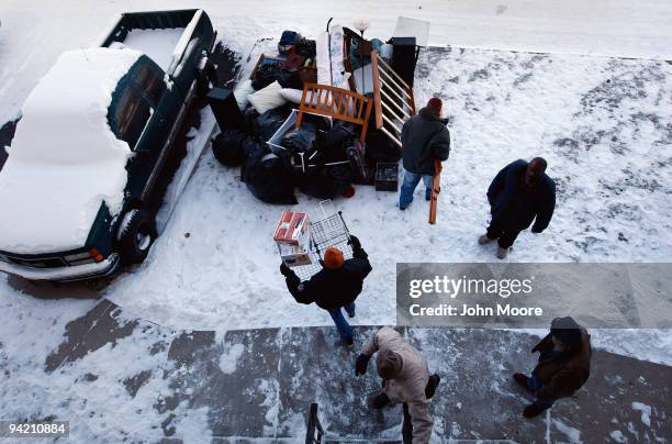 An eviction team removes furniture from an apartment on December 9, 2009 in Colorado Springs, Colorado. The tenants had fallen two behind months in...