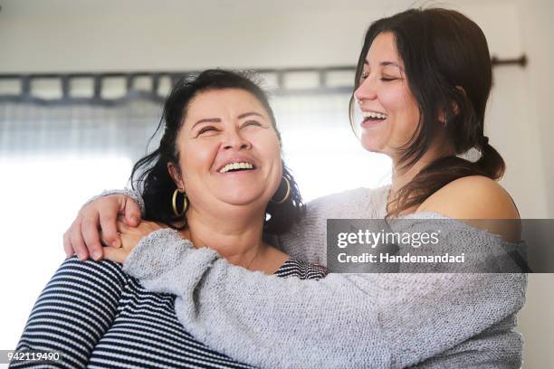 Positive senior mother and her daughter embracing