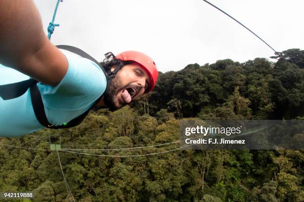 selfie of man practicing canopy in costa rica - zip line stockfoto's en -beelden