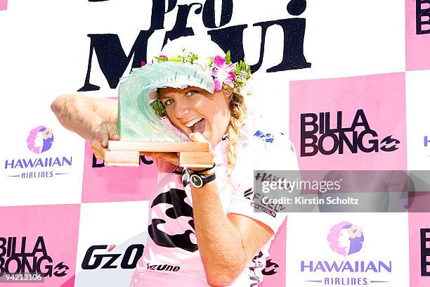 Stephanie Gilmore of Australia smiles through her glass barrel trophy after winning the Billabong Pro Maui on December 9, 2009 in Honolua Bay, Maui,...