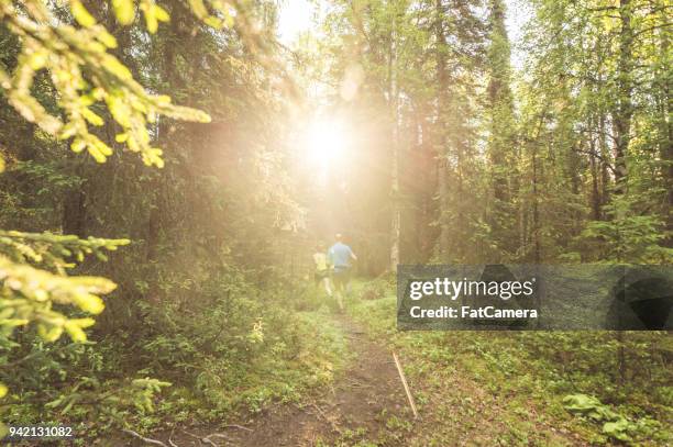 medelålders par terränglöpning i skogen - fat guy running bildbanksfoton och bilder